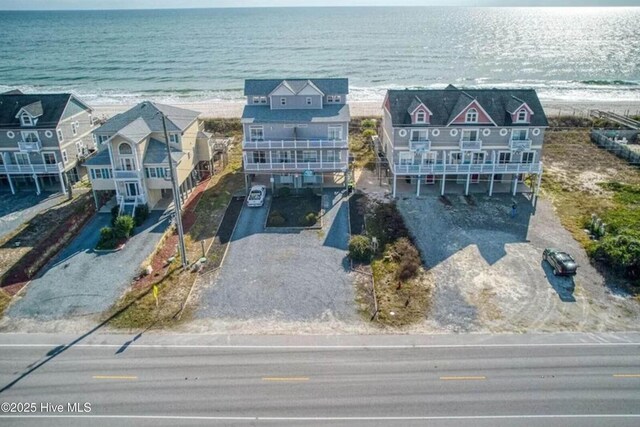 drone / aerial view featuring a water view and a view of the beach