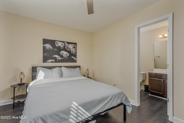 bedroom with ensuite bath, dark wood-type flooring, and ceiling fan