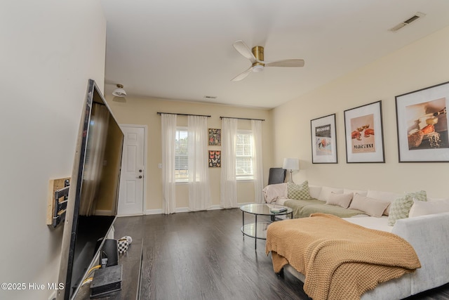 living room with ceiling fan and dark hardwood / wood-style flooring