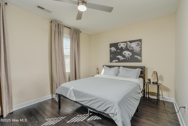 bedroom with dark hardwood / wood-style floors and ceiling fan