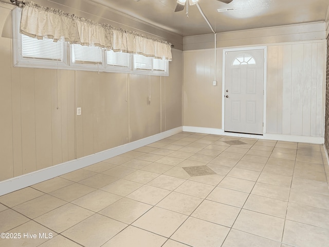 tiled entryway with ceiling fan