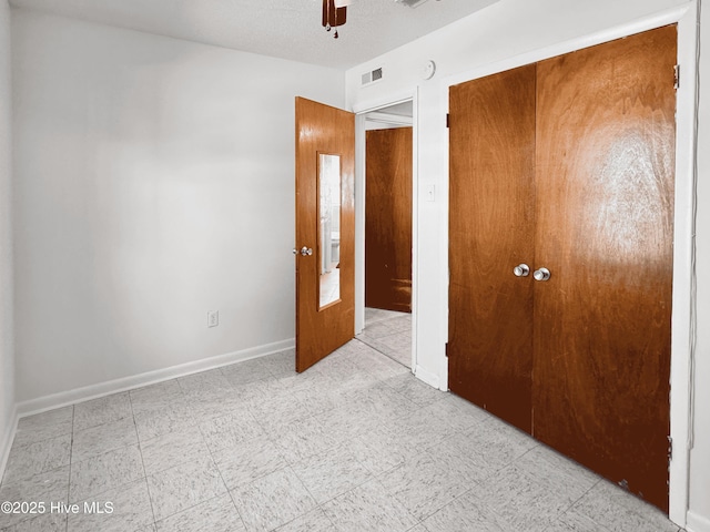 unfurnished bedroom featuring a closet and ceiling fan