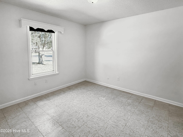 unfurnished room featuring a textured ceiling