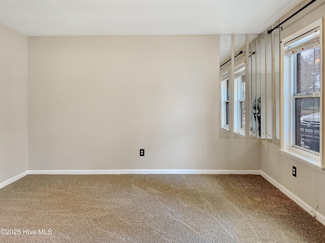 unfurnished room featuring carpet