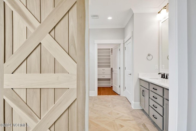 bathroom featuring vanity and parquet flooring