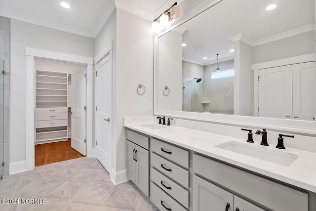 bathroom featuring parquet floors, ornamental molding, a shower with shower door, and vanity