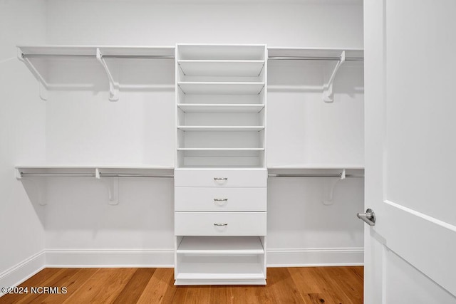 walk in closet featuring hardwood / wood-style flooring