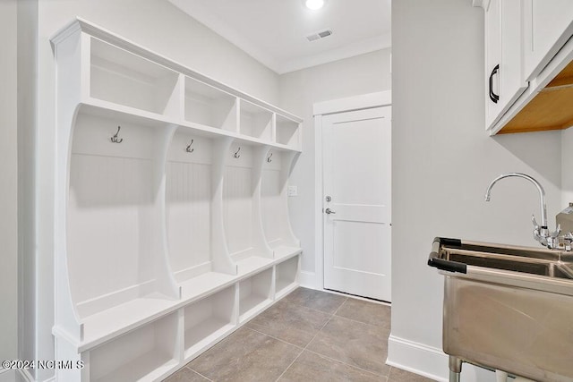 mudroom featuring light tile patterned floors and sink