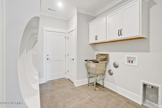 laundry room with washer hookup, cabinets, light tile patterned flooring, and crown molding