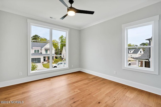 unfurnished room featuring crown molding, a healthy amount of sunlight, wood-type flooring, and ceiling fan