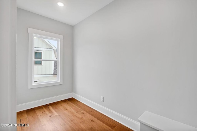 empty room with hardwood / wood-style flooring