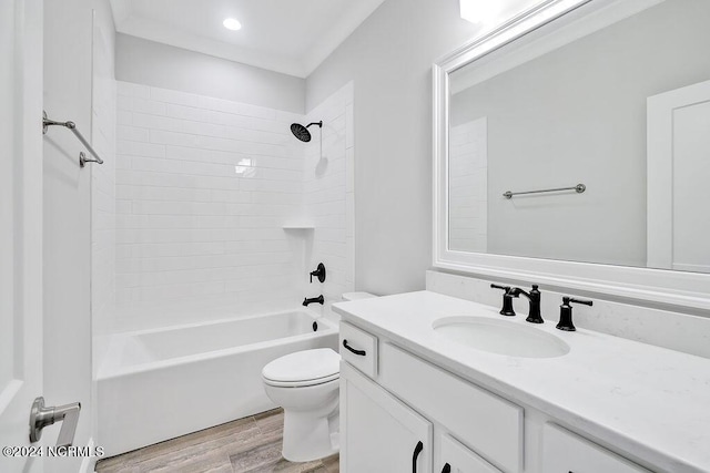 full bathroom with shower / bath combination, hardwood / wood-style floors, toilet, and vanity