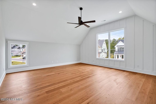 additional living space featuring ceiling fan, lofted ceiling, and light hardwood / wood-style flooring