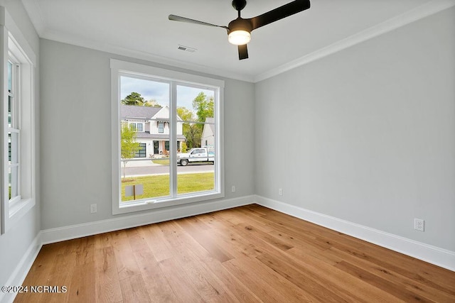 spare room with light hardwood / wood-style floors, ornamental molding, and ceiling fan