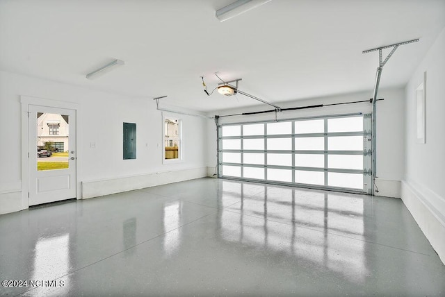 garage with a garage door opener and electric panel