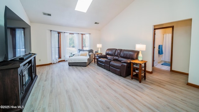 3 Bayberry Cir, Carolina Shores, NC 28467 - living room featuring a skylight, light wood-type flooring, and high vaulted ceiling