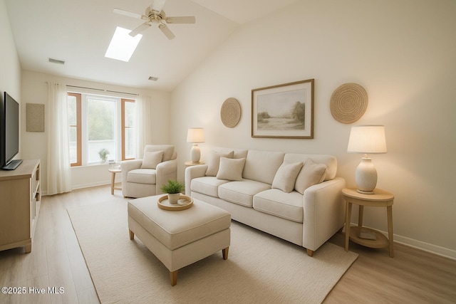 3 Bayberry Cir, Carolina Shores, NC 28467 - living area featuring a ceiling fan, light wood finished floors, vaulted ceiling, and a skylight