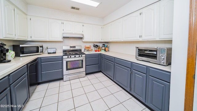 3 Bayberry Cir, Carolina Shores, NC 28467 - kitchen featuring stainless steel appliances, under cabinet range hood, white cabinetry, light countertops, and decorative backsplash