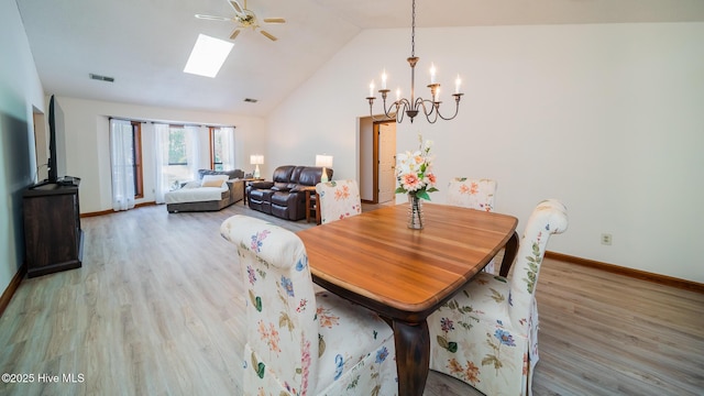 3 Bayberry Cir, Carolina Shores, NC 28467 - dining room with a chandelier, wood finished floors, vaulted ceiling, a skylight, and ceiling fan
