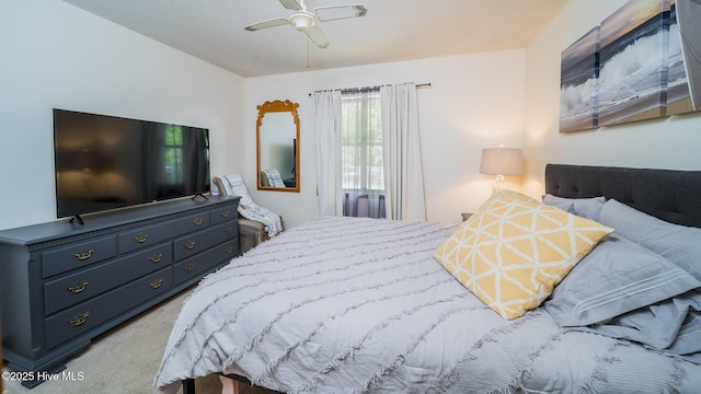 bedroom with a textured ceiling, light colored carpet, and ceiling fan