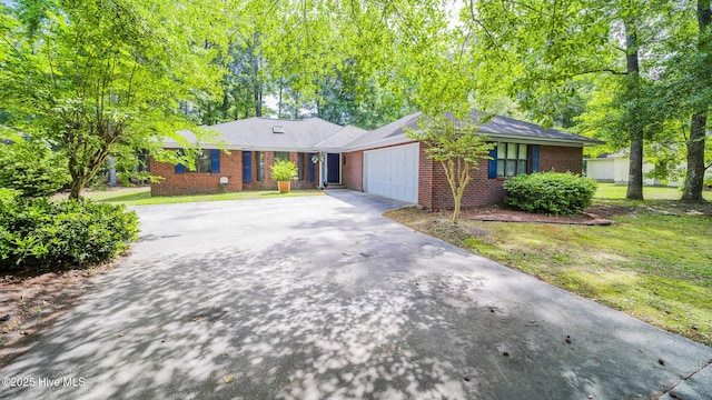 3 Bayberry Cir, Carolina Shores, NC 28467 - single story home with brick siding, asphalt driveway, a garage, and a front lawn