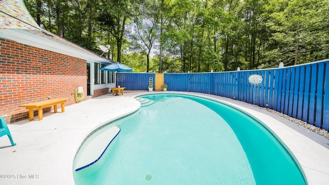 3 Bayberry Cir, Carolina Shores, NC 28467 - view of pool with a fenced backyard, view of scattered trees, and a patio