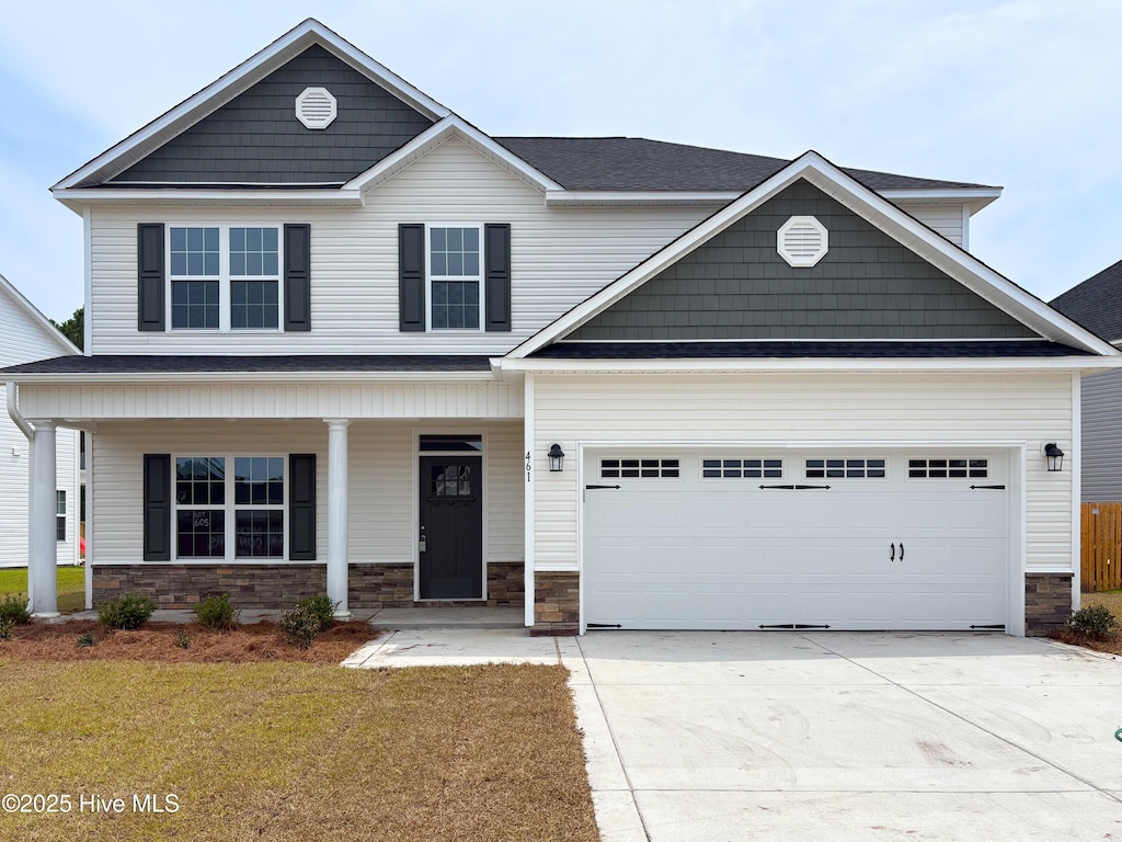 461 Pebble Shore Dr, Sneads Ferry, NC 28460 - craftsman inspired home featuring stone siding, driveway, a porch, a front lawn, and an attached garage