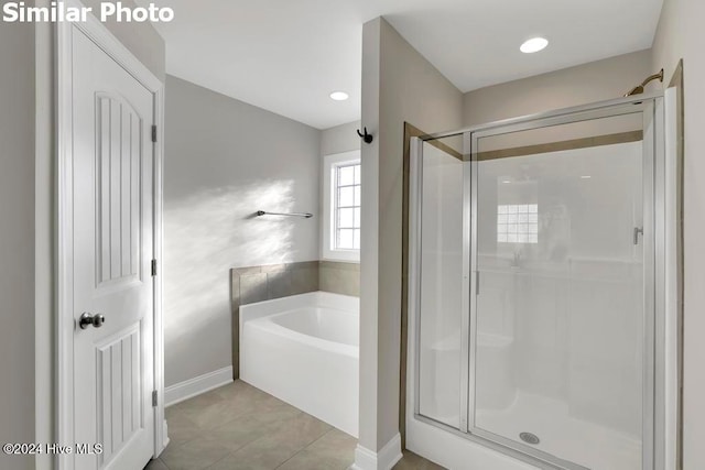 bathroom featuring shower with separate bathtub