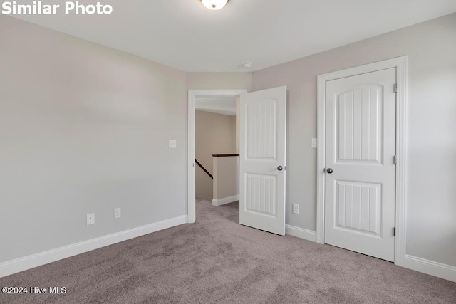 unfurnished bedroom featuring light colored carpet