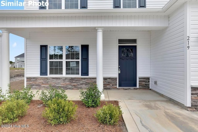 doorway to property featuring covered porch