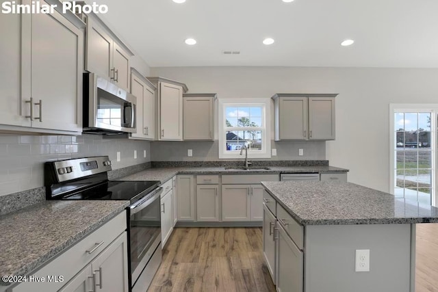 kitchen featuring light hardwood / wood-style flooring, sink, gray cabinets, and stainless steel appliances