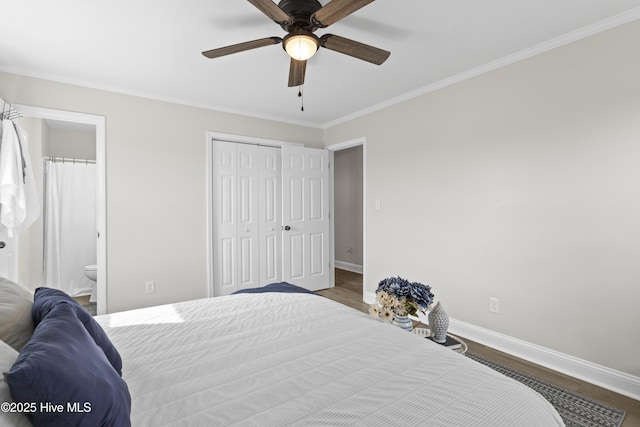 bedroom with ensuite bathroom, baseboards, a closet, dark wood finished floors, and crown molding