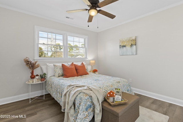 bedroom with wood finished floors, visible vents, and baseboards