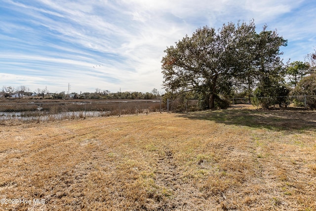 view of yard with a rural view and fence