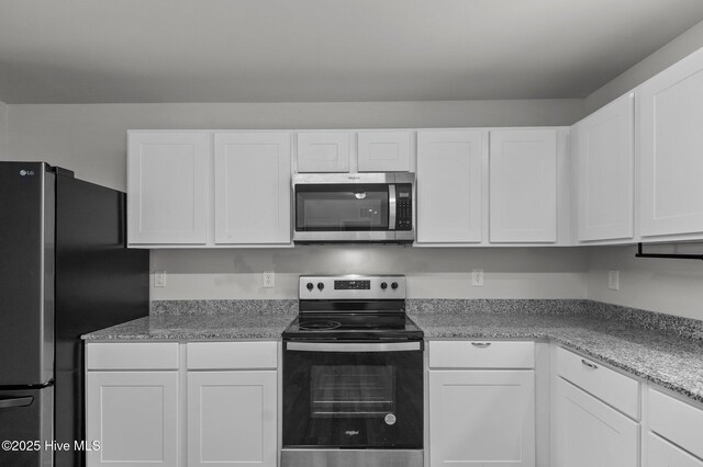 135 Chase Dr, Snow Hill, NC 28580 - kitchen featuring a sink, light stone counters, stainless steel dishwasher, and white cabinetry