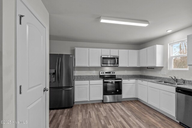 135 Chase Dr, Snow Hill, NC 28580 - kitchen with a sink, light stone counters, stainless steel appliances, and dark wood-style flooring