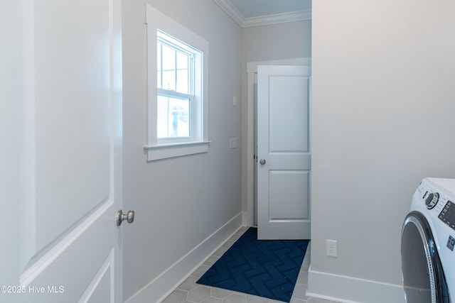 clothes washing area featuring washer / clothes dryer and ornamental molding