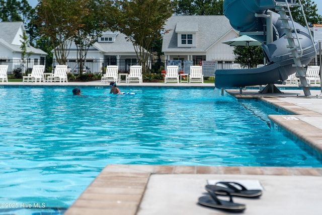 view of pool with a water slide