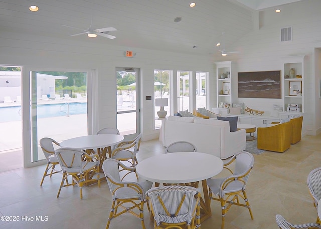 dining space with lofted ceiling, wood ceiling, built in shelves, and ceiling fan