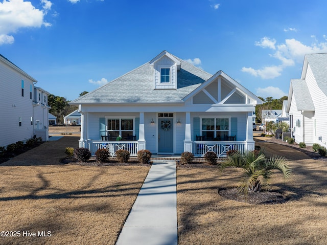 view of front of property with a porch and a front lawn