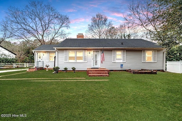 ranch-style house featuring a yard