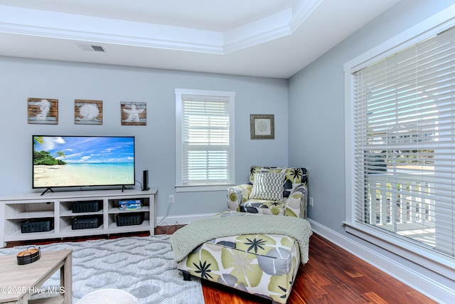 sitting room featuring ornamental molding, a tray ceiling, and dark hardwood / wood-style flooring