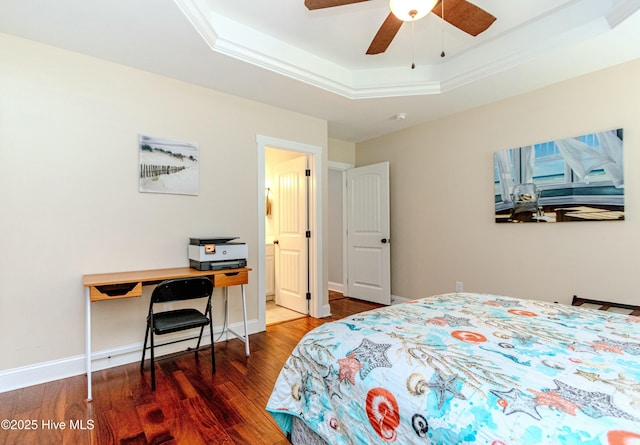 bedroom with ceiling fan, ornamental molding, dark hardwood / wood-style flooring, and a raised ceiling