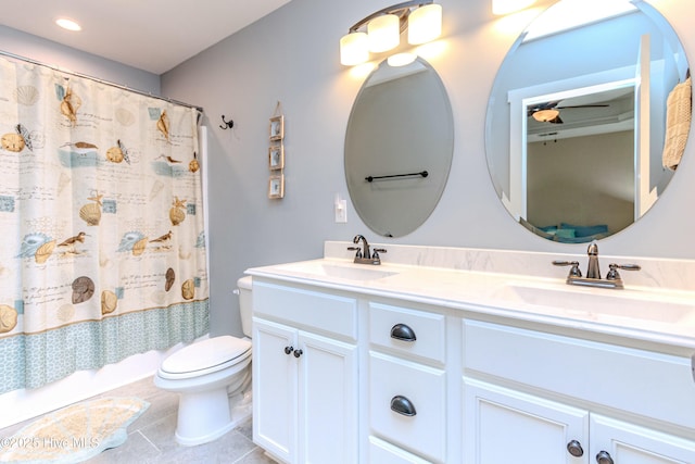 full bathroom with vanity, tile patterned floors, toilet, and shower / bath combo with shower curtain