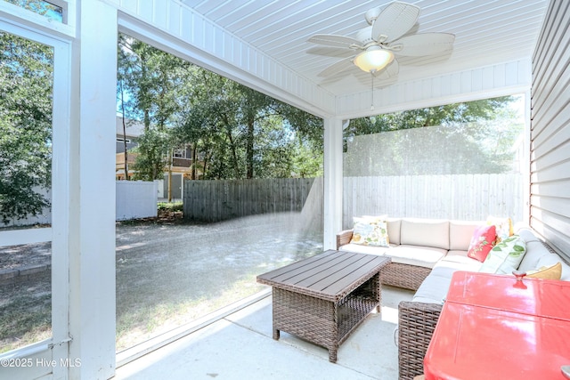 sunroom / solarium featuring ceiling fan