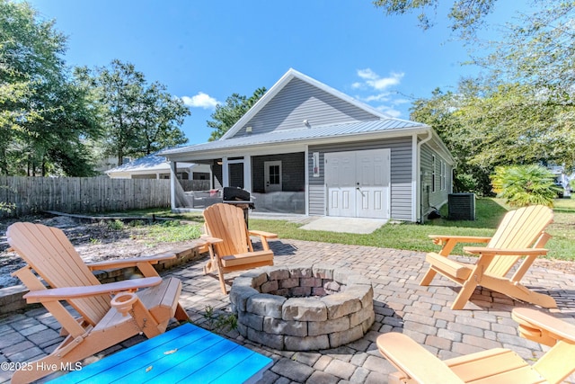 exterior space with a patio, central AC unit, and a fire pit