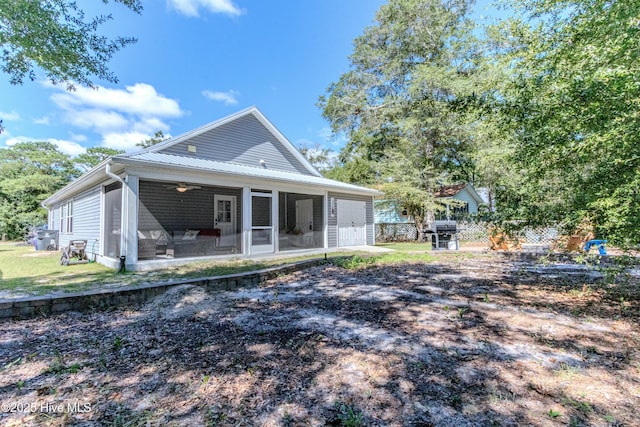 rear view of property with a sunroom