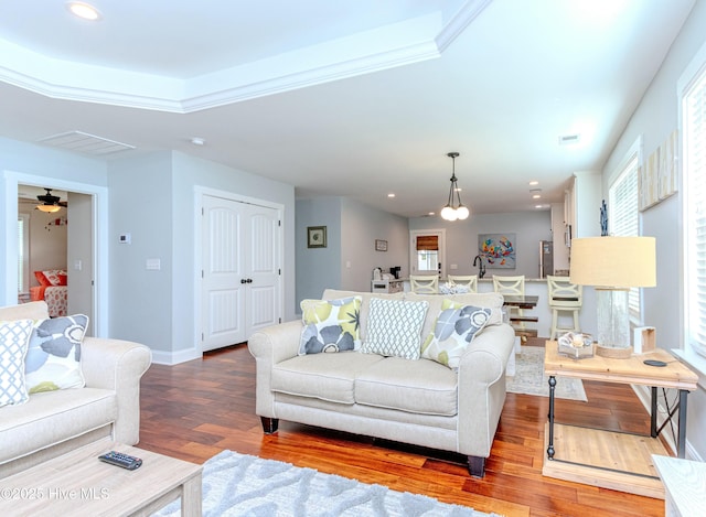 living room featuring hardwood / wood-style flooring and crown molding