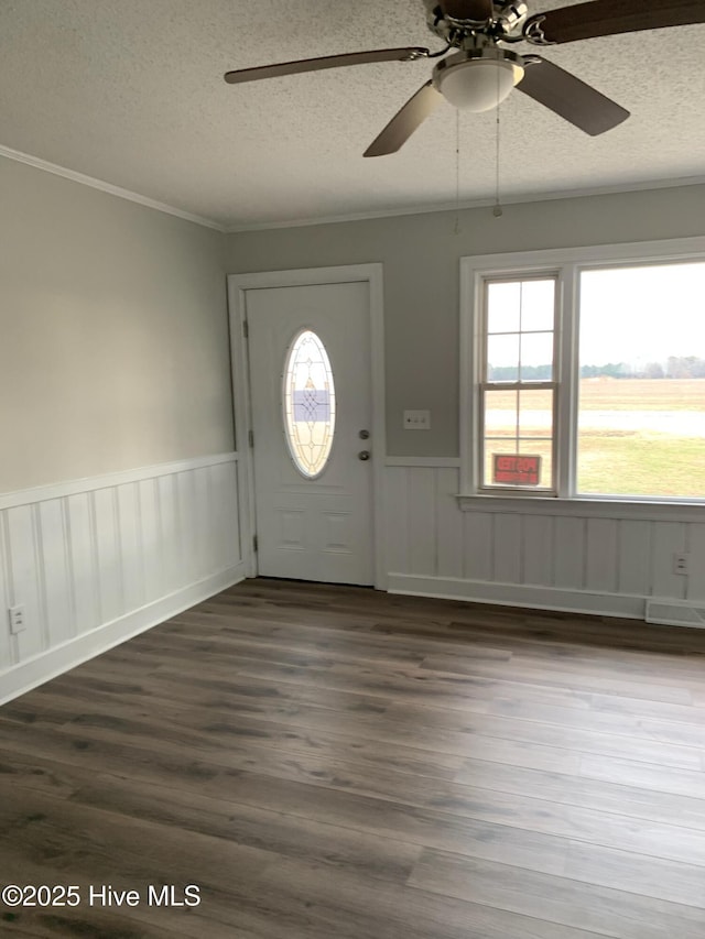 foyer entrance featuring crown molding, a textured ceiling, and hardwood / wood-style flooring