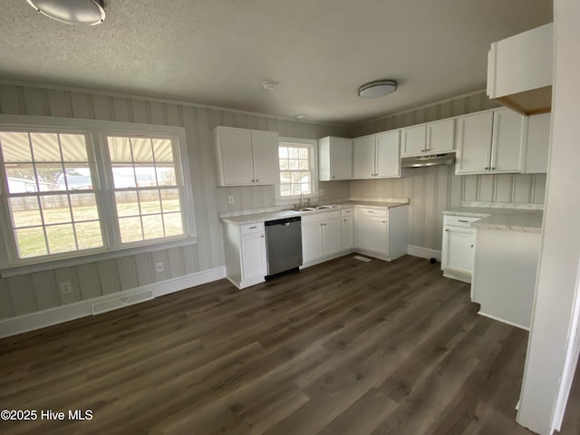 kitchen featuring sink, white cabinetry, stainless steel dishwasher, and dark hardwood / wood-style floors